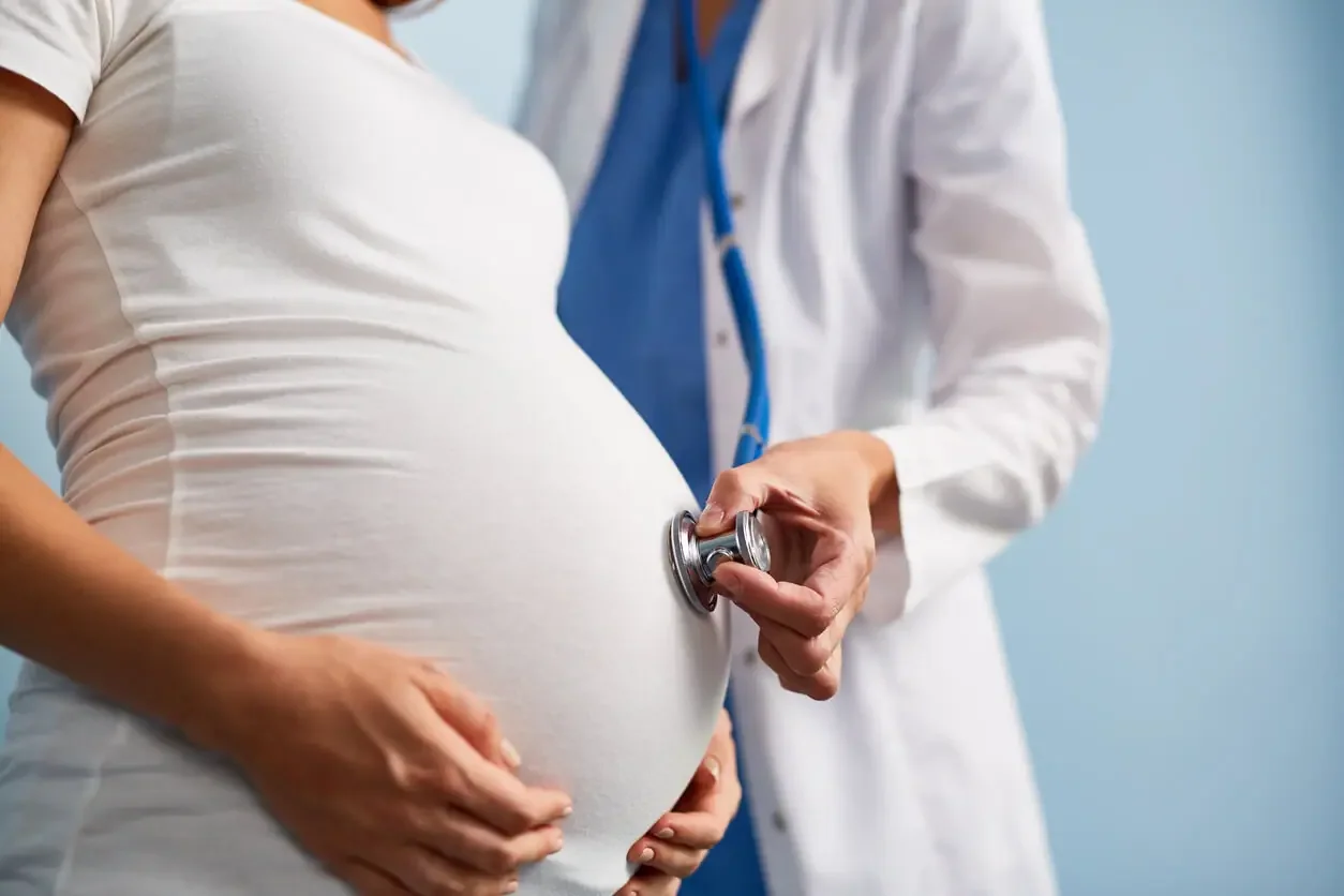 Doctor examining a pregnant patient with a stethoscope